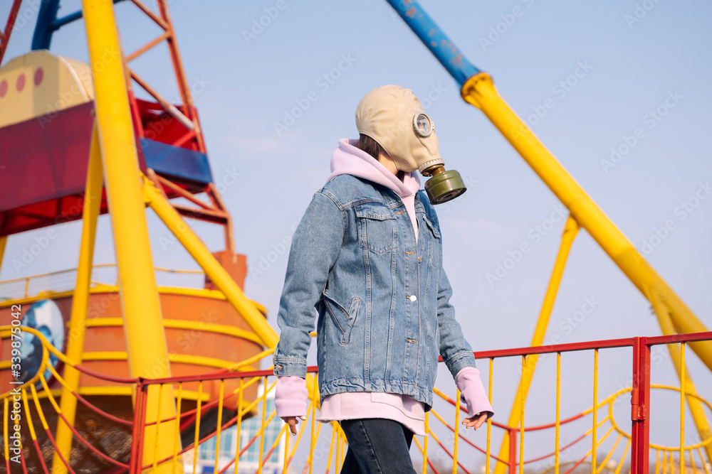a girl in a gas mask walks around the city, the beach a girl in a gas mask walks around the city, the beach