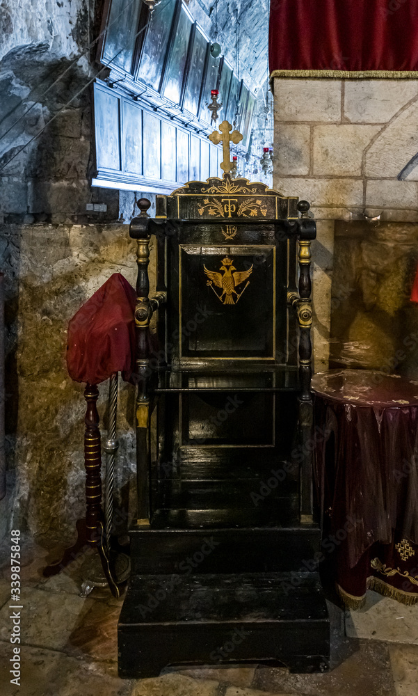 Archbishop wooden chair stands in the Tomb of the Virgin on foot of the mountain Mount Eleon - Mount of Olives in East Jerusalem in Israel