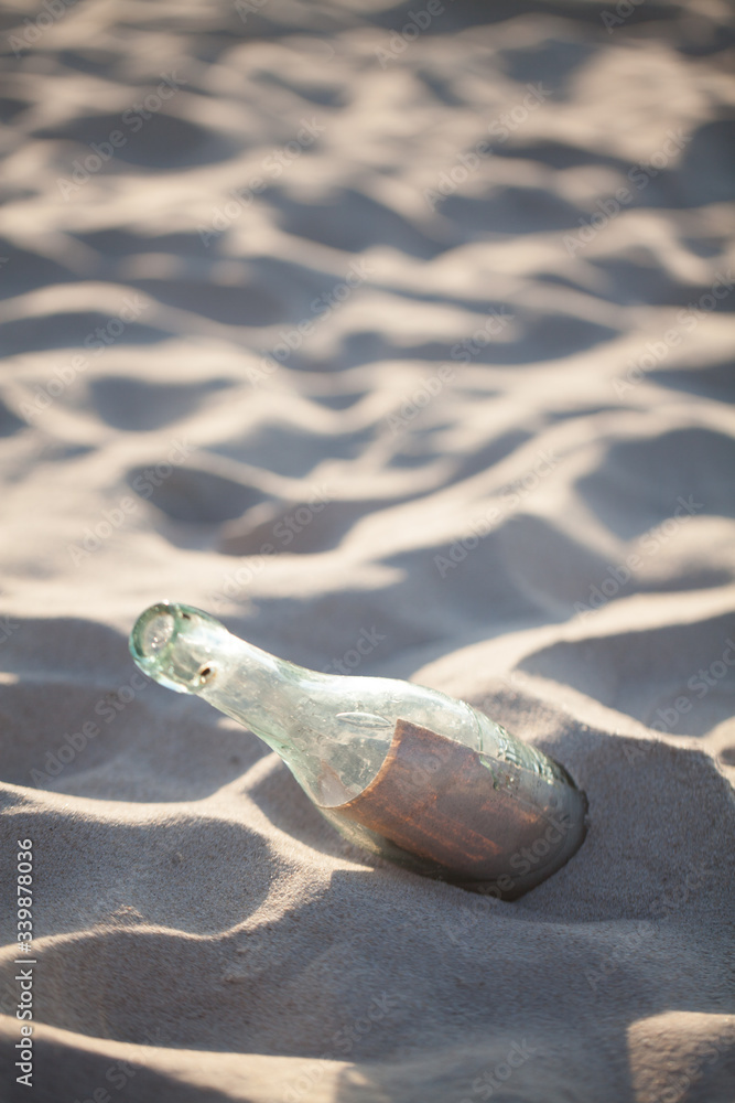 Letter in the bottle. A bottle with a letter buried on the beach