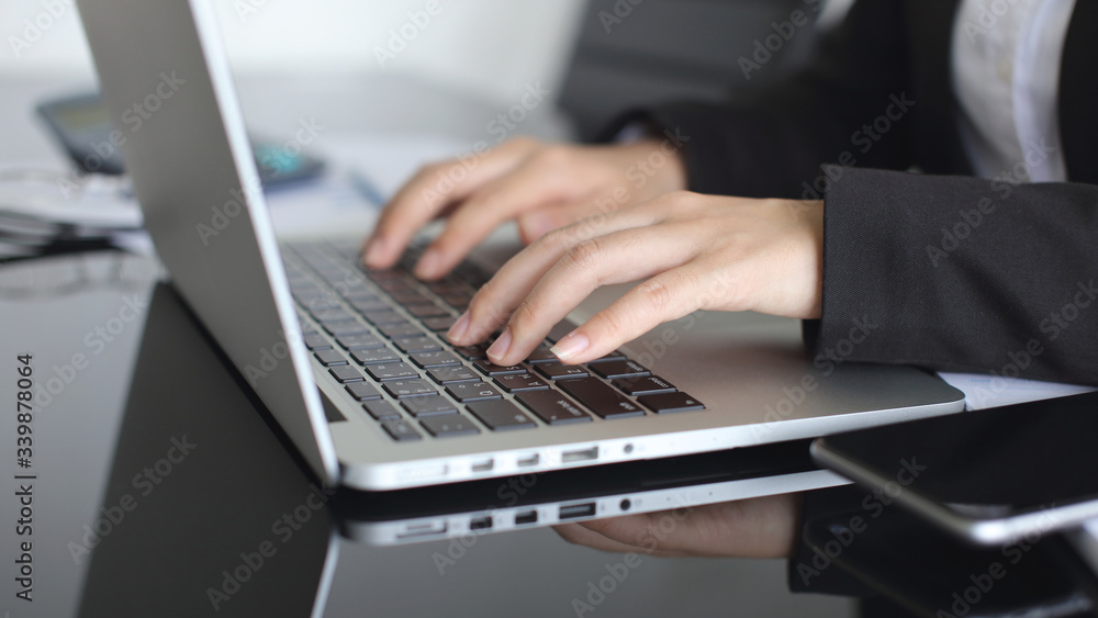 close up businesswoman working with laptop in the office. close up businesswoman working with laptop in the office.
