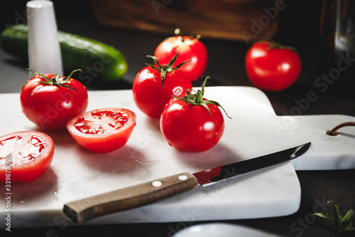 Cherry tomatoes on a white marble tray. photo