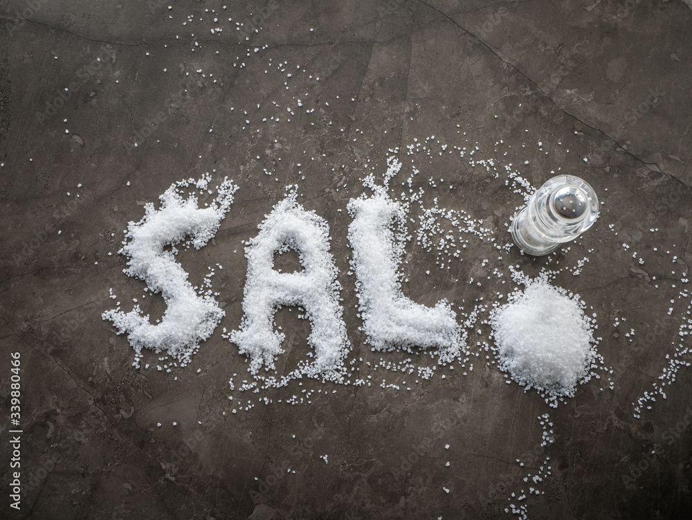 Spanish word SAL (SALT in English) written in salt grains spread on a
