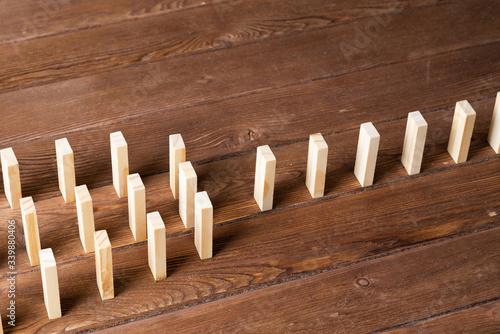 Rows of dominoes standing on wooden table