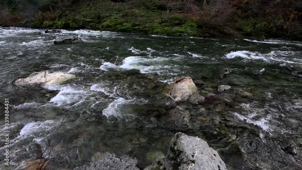 Left to right pan from upstream to downstream of a rocky stretch of the Illinois River in Southern Oregon on a rainy day Left to right pan from upstream to downstream of a rocky stretch of the Illinois River in Southern Oregon on a rainy day