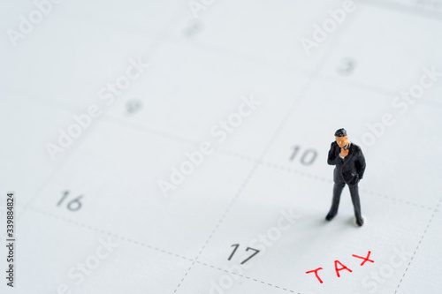 miniture business model on calender.Tax management concepts.