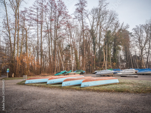 Fotografie, Obraz Rowboats Moored On Field Against Trees