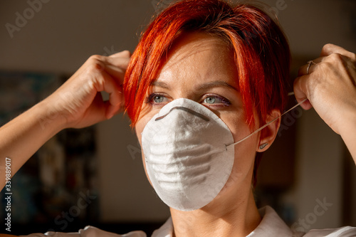 face of young woman in putting on face mask