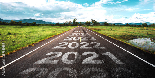 2020-2025 written on highway road in the middle of empty asphalt road at golden sunset and beautiful blue sky. Concept for vision 2020-2025. photo