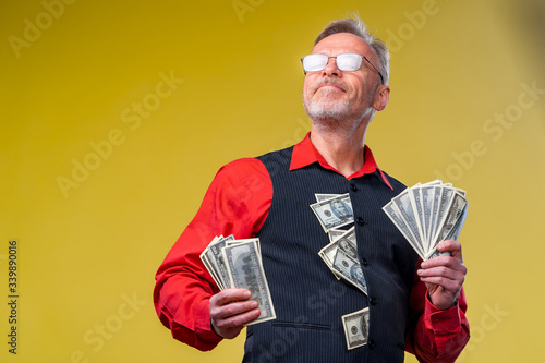 Tablou pe pânză Senior man guy won the lottery, fan of money near face of old man