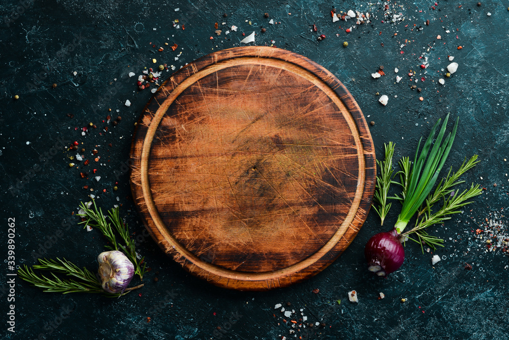 Food background. Kitchen board on the table with spices and herbs. Top view. Food background. Kitchen board on the table with spices and herbs. Top view.