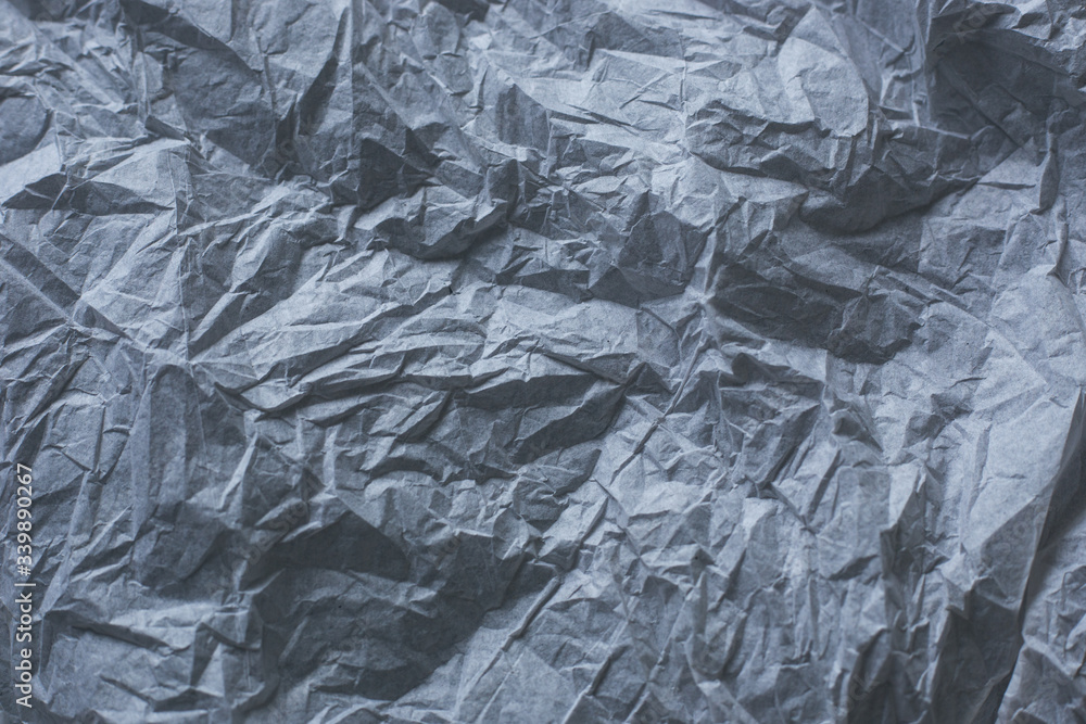 background from crumpled texture paper of dark gray color background from crumpled texture paper of dark gray color