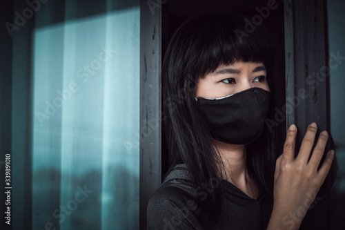 Asian woman wearing a black...
