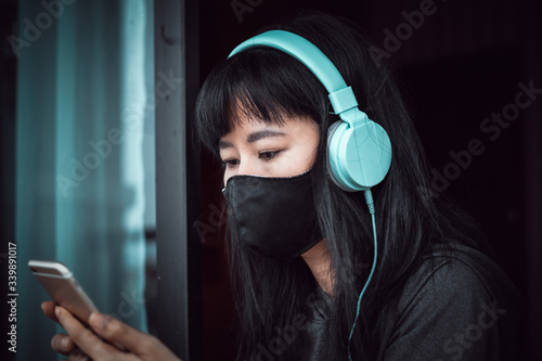 Asian woman wearing a black...