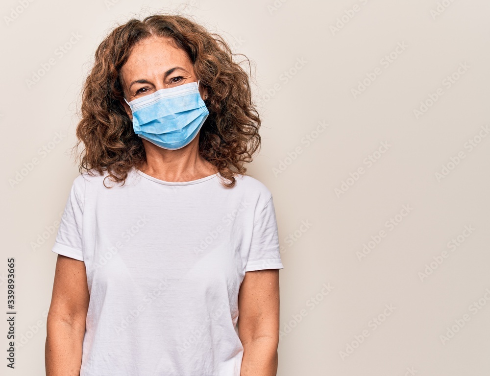 Middle age woman wearing coronavirus protection mask for covid-19 epidemic virus with a happy and cool smile on face. Lucky person. Middle age woman wearing coronavirus protection mask for covid-19 epidemic virus with a happy and cool smile on face. Lucky person.