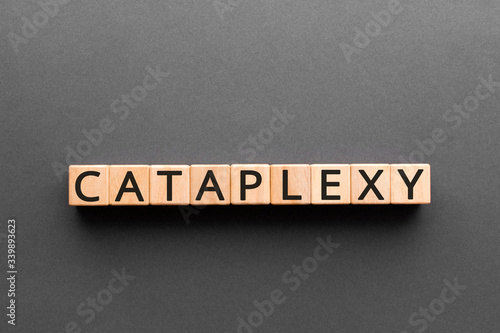Cataplexy - word from wooden blocks with letters, cataplexy concept, black background