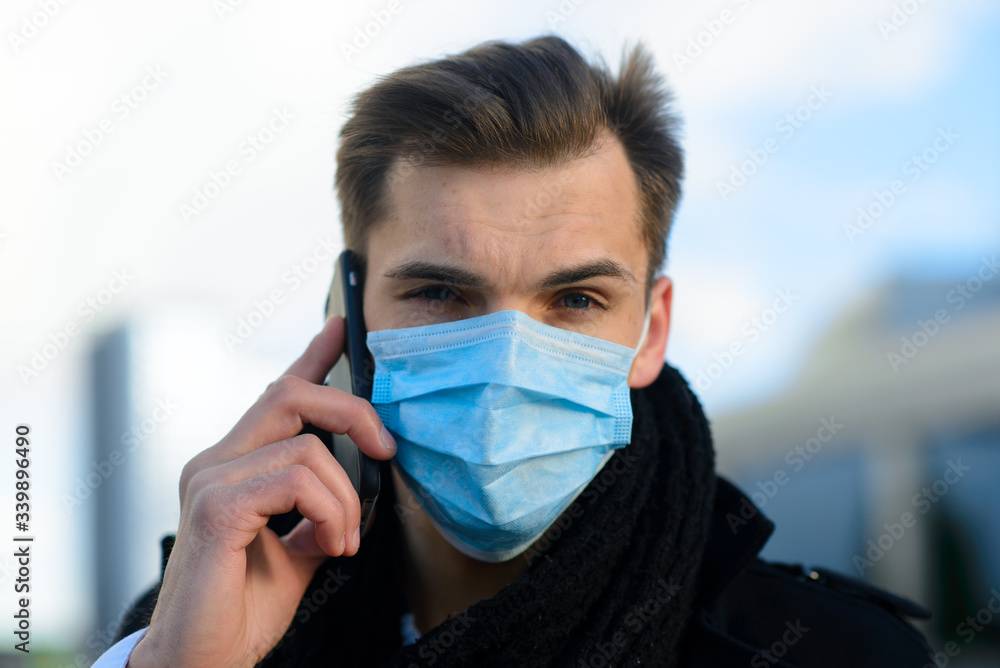 People with face mask. Concept with copy space. Portrait of adult man in quarantine of flu. Photo on the street in the city People with face mask. Concept with copy space. Portrait of adult man in quarantine of flu. Photo on the street in the city