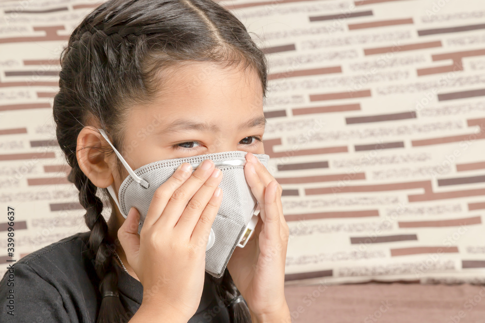 Asian little girl wearing an N95 mask Asian little girl wearing an N95 mask