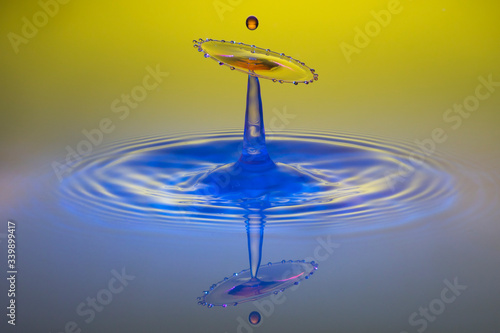 water drop collision on yellow background