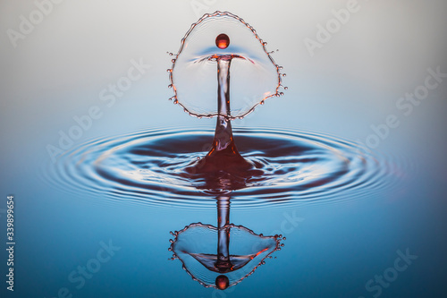red water drop collision on blue background