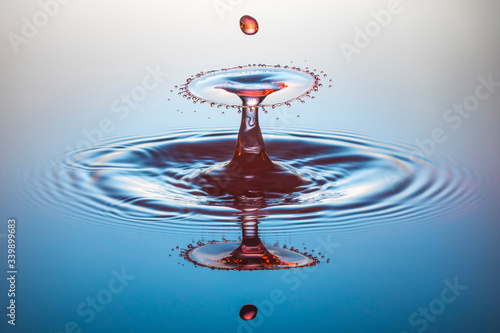 red water drop collision on blue background