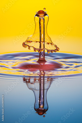 water drop collision on yellow background