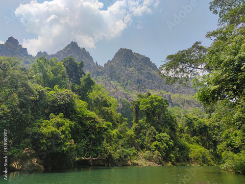 Green jungles in mountains. Green forest and water reflection.
