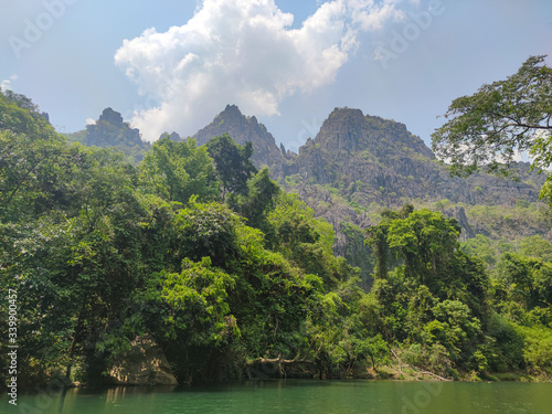 Green jungles in mountains. Green forest and water reflection.
