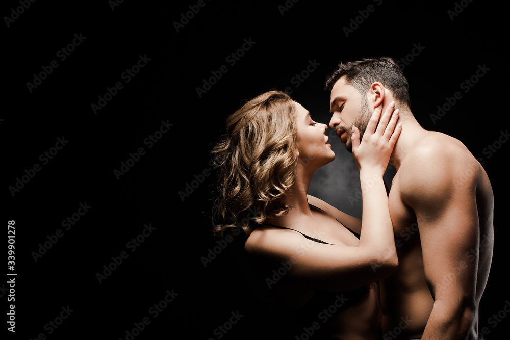 side view of sensual girl touching face of sexy boyfriend on black background side view of sensual girl touching face of sexy boyfriend on black background