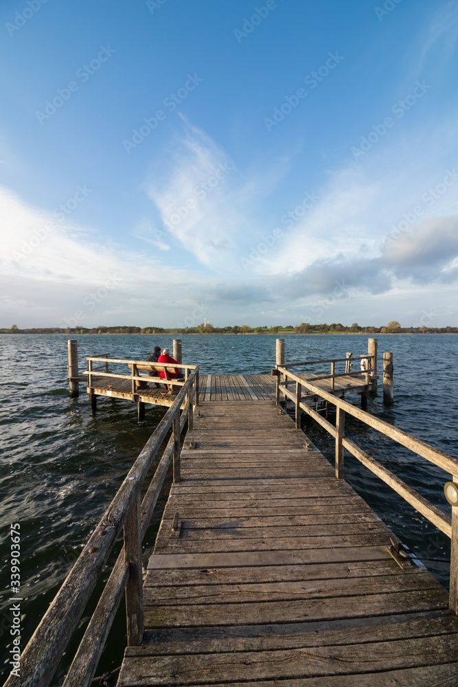 Fototapeta premium beautiful lake scene with row boat and golden evening sun, calming effect, romatic landscape