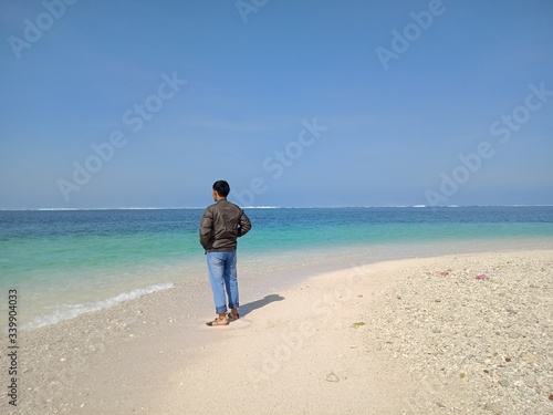 young man walking on the beach