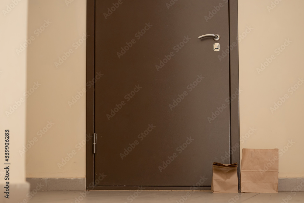 Cardboard boxes near front door of apartment. Food delivery and shopping during coronavirus pandemic Cardboard boxes near front door of apartment. Food delivery and shopping during coronavirus pandemic