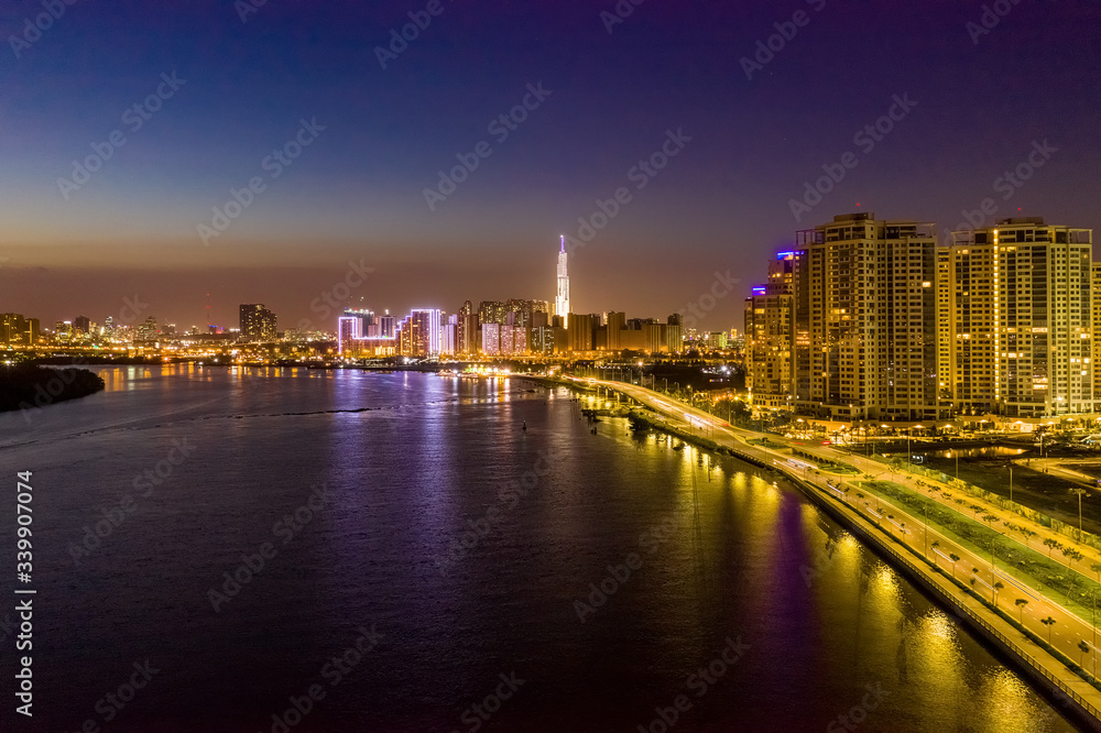 Fototapeta premium Top view aerial of a Ho Chi Minh City with development buildings, transportation, energy power infrastructure. View from Diamond island, District 2. Sai Gon, Vietnam