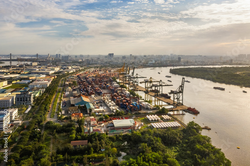 Logistics and transportation of Container Cargo ship and Cargo plane with working crane bridge in shipyard  logistic import export and transport industry background  Ho Chi Minh city  Vietnam