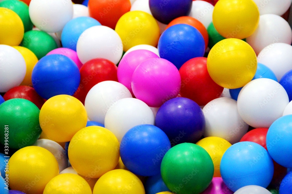 Fototapeta premium bright multi-colored balls for dry pool, solid background, selective focus