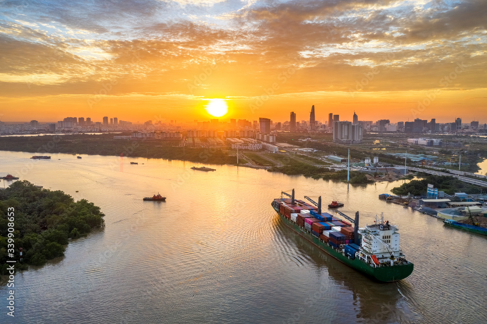 Naklejka premium Aerial view of center Ho Chi Minh City, Vietnam with development buildings, transportation, energy power infrastructure. View from the Saigon river with ships on the river.