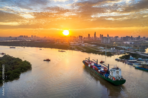 Aerial view of center Ho Chi Minh City, Vietnam with development buildings, transportation, energy power infrastructure. View from the Saigon river  with ships on the river. 