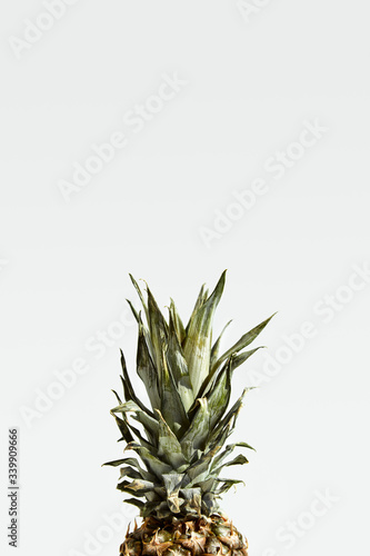  Ripe juicy pineapple fruit with green leaves isolated on white.