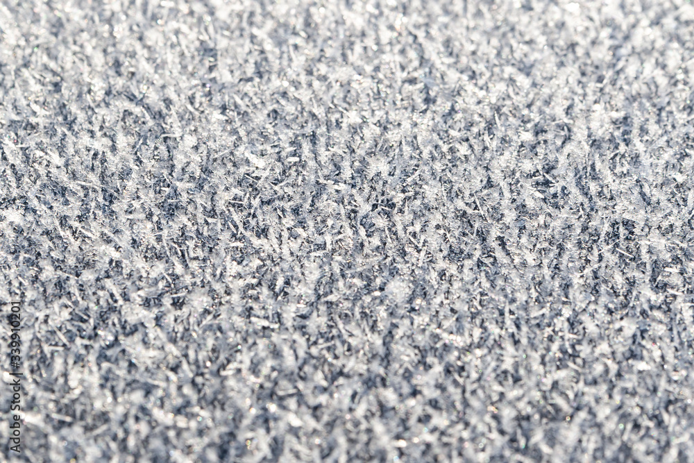 The surface is covered with hoarfrost, closeup, selective focus. The surface is covered with hoarfrost, closeup, selective focus.