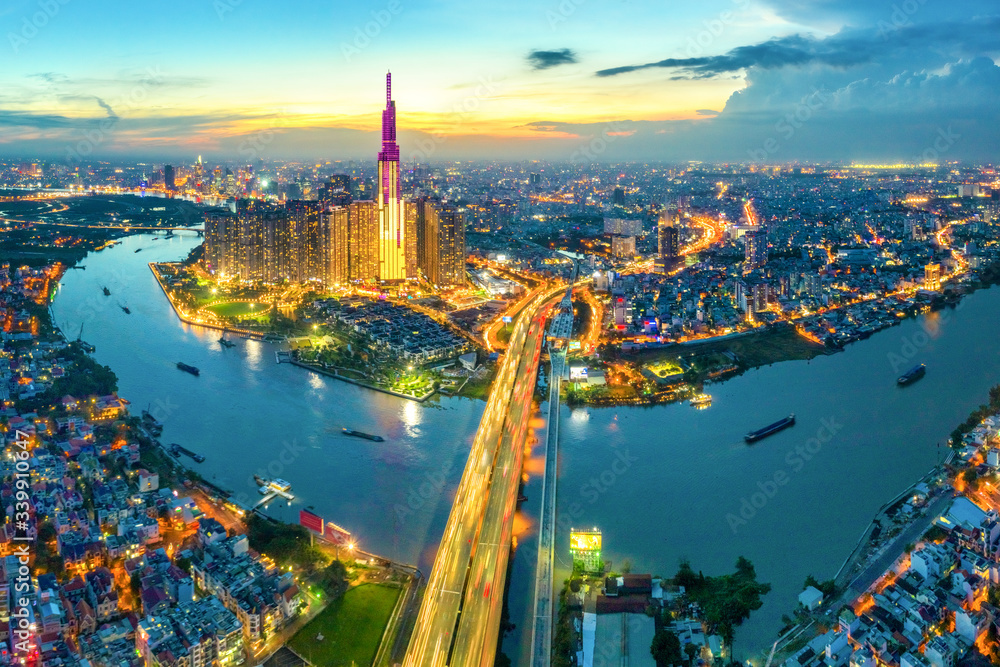 Naklejka premium Top view aerial of center Ho Chi Minh City and Saigon bridge with development buildings, transportation, energy power infrastructure. Financial and business centers in Vietnam. View from District 2