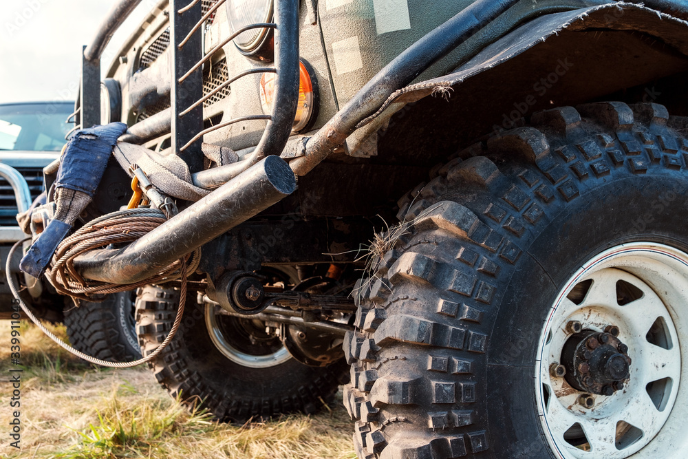 the front of the car with large wheels and sports treads on the tire is dirty after driving the front of the car with large wheels and sports treads on the tire is dirty after driving