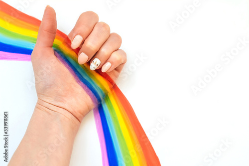 hand with unicorn manicure on white background