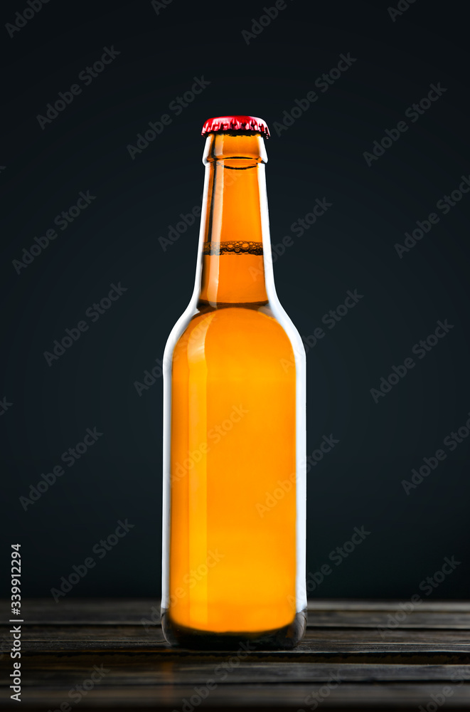 Bottle of beer isolated on wood background, clipping path. Bottle of beer isolated on wood background, clipping path.