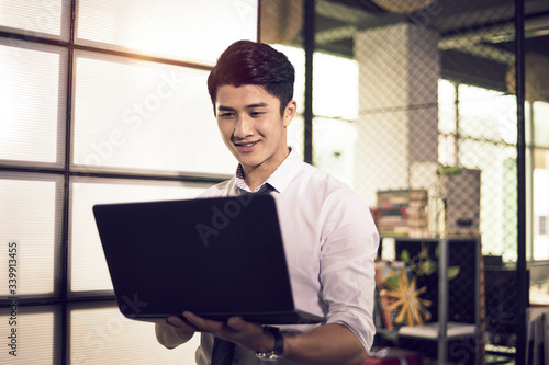 Canvas Print young asian business person entrepreneur using laptop computer in office happy a