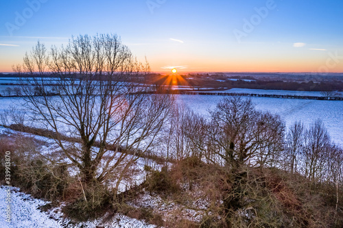 sunrise over the snowy countryside