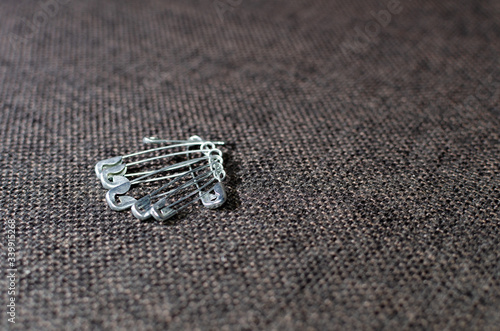 several pins on gray fabric