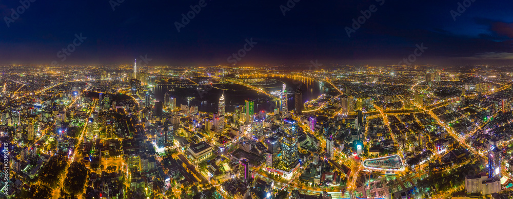 Top view aerial of Thu Thiem peninsula and center Ho Chi Minh City with development buildings, transportation, energy power infrastructure. Financial and business centers in developed Vietnam Top view aerial of Thu Thiem peninsula and center Ho Chi Minh City with development buildings, transportation, energy power infrastructure. Financial and business centers in developed Vietnam