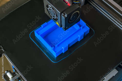 Obraz na płótnie The 3D printer prints blue plastic model