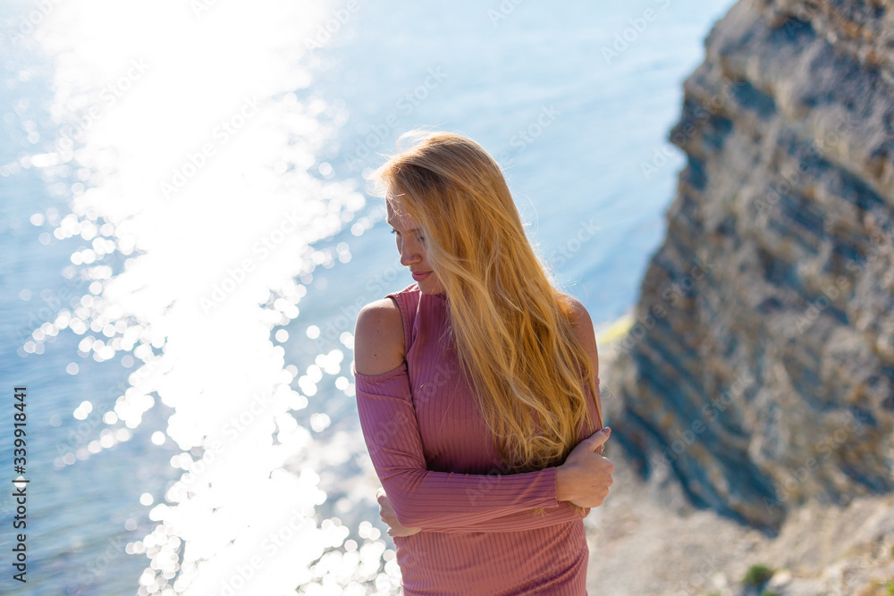 blonde model on the beach at the summer