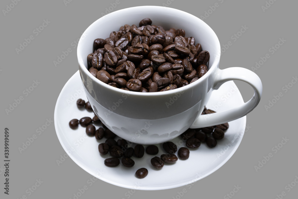 Coffee beans in a white mug on a gray background Coffee beans in a white mug on a gray background