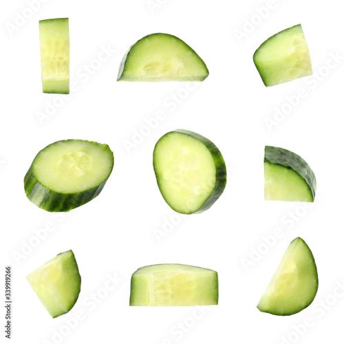 Set of fresh cucumber slices on white background